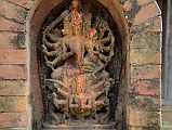 Kathmandu Changu Narayan 31 10 Armed Vaikuntha Vishnu With Lakshmi On His Lap Rides On Garuda In The North East Corner Of Changu Narayan A 16C statue of Vaikuntha Vishnu with 10 arms and 4 heads, including two boar heads, and Lakshmi (Laxmi) on his lap rides a six-armed Garuda in the north east corner of Changu Narayan.